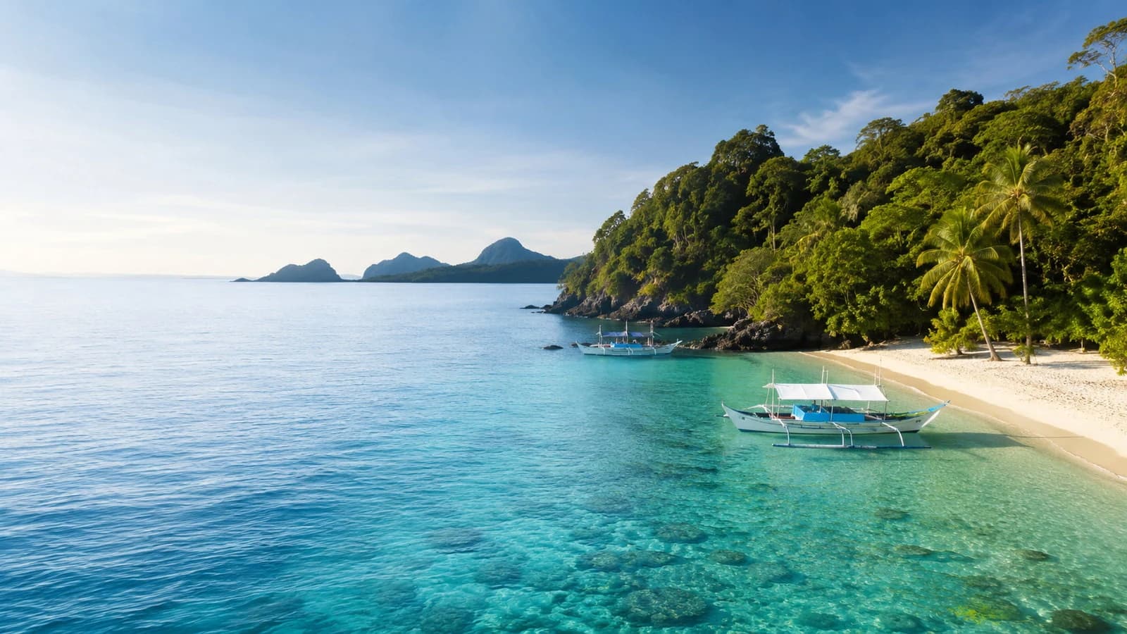 Tropical Philippine coast with clear water and an outrigger boat